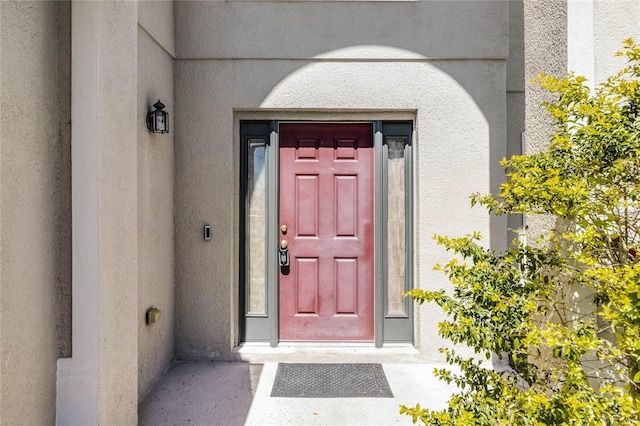 entrance to property with stucco siding