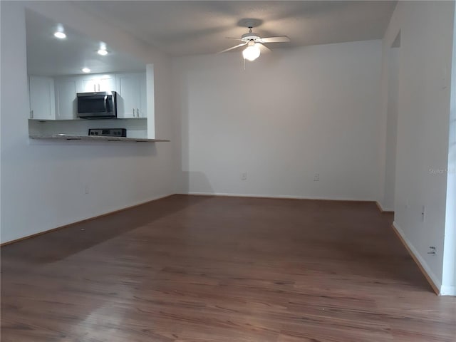 unfurnished living room with hardwood / wood-style floors and ceiling fan