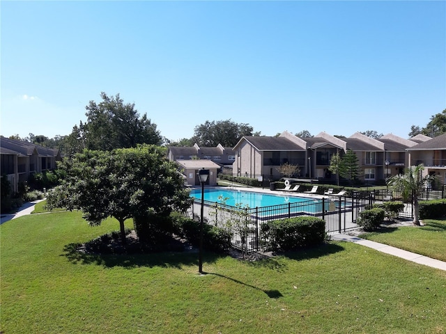 view of pool with a yard