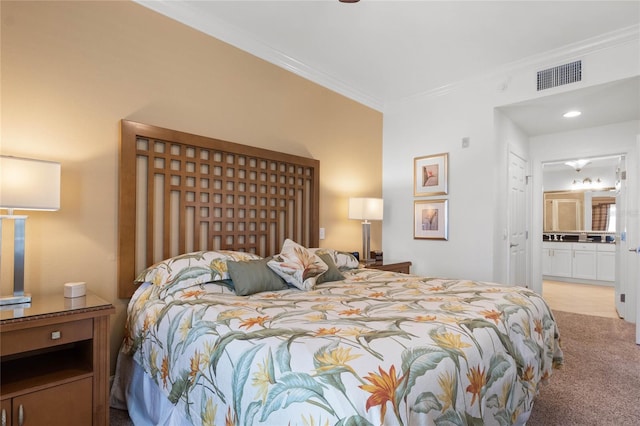 bedroom with ensuite bathroom, light colored carpet, and crown molding