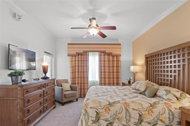 carpeted bedroom featuring ceiling fan and crown molding