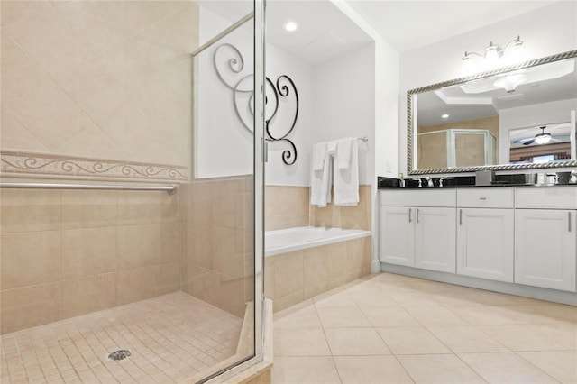 bathroom with tile patterned floors, vanity, ceiling fan, and plus walk in shower