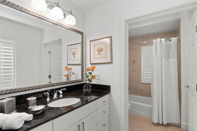 full bathroom featuring toilet, shower / bath combo with shower curtain, vanity, and tile patterned flooring