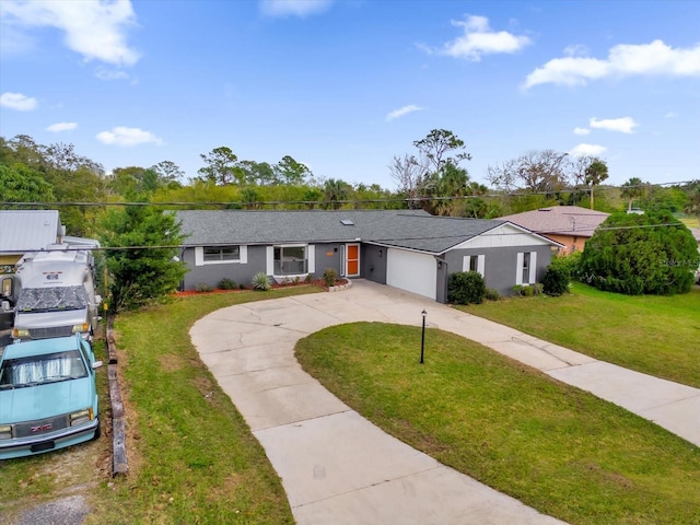 ranch-style home with a garage and a front lawn