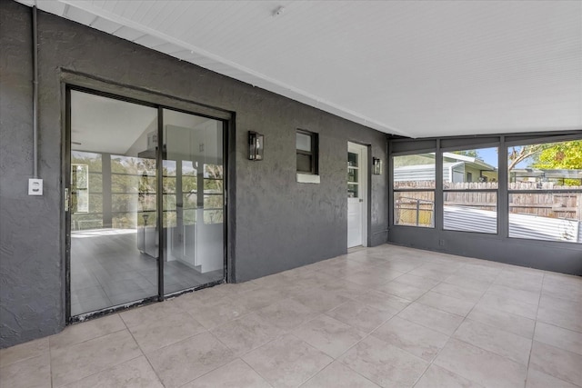 unfurnished sunroom with vaulted ceiling