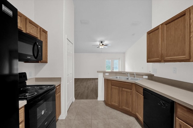 kitchen featuring light tile patterned flooring, black appliances, sink, ceiling fan, and kitchen peninsula