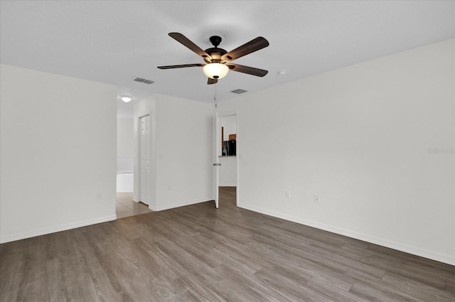 spare room featuring light hardwood / wood-style floors and ceiling fan