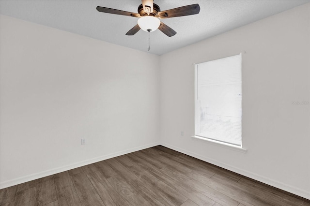 empty room featuring wood-type flooring and ceiling fan