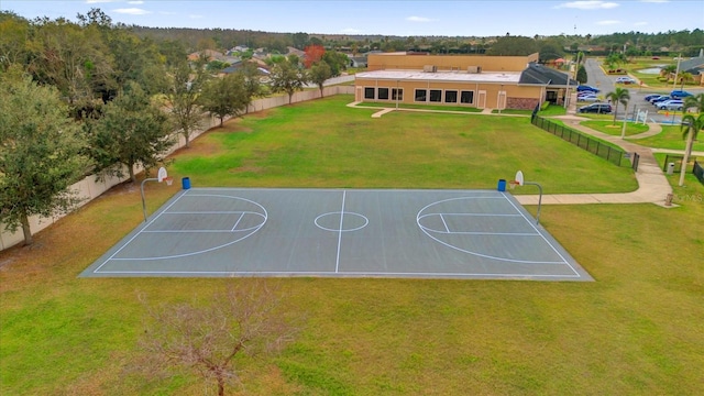 view of basketball court with a yard