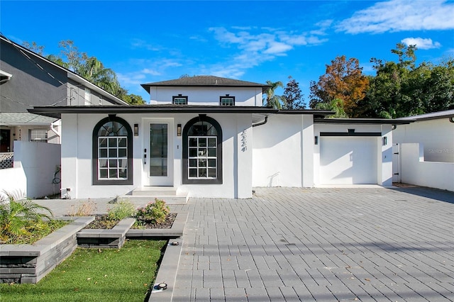 back of property featuring a garage