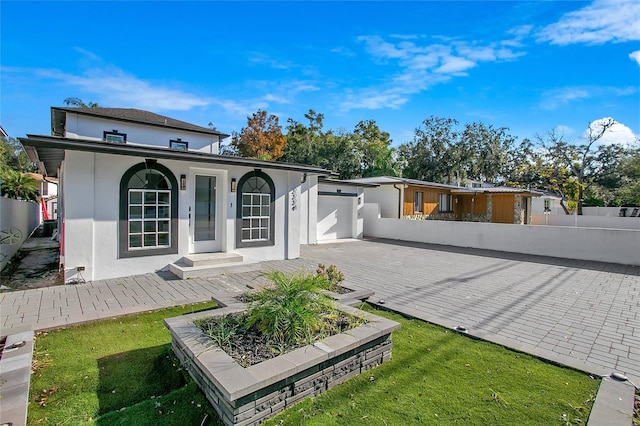 rear view of property featuring a garage