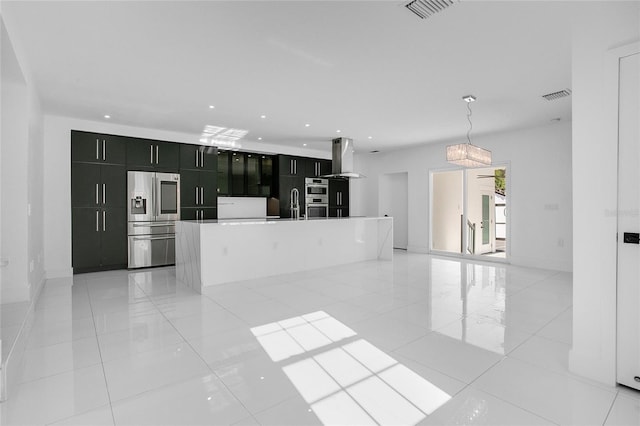 kitchen featuring hanging light fixtures, stainless steel fridge with ice dispenser, ventilation hood, a center island with sink, and light tile patterned floors