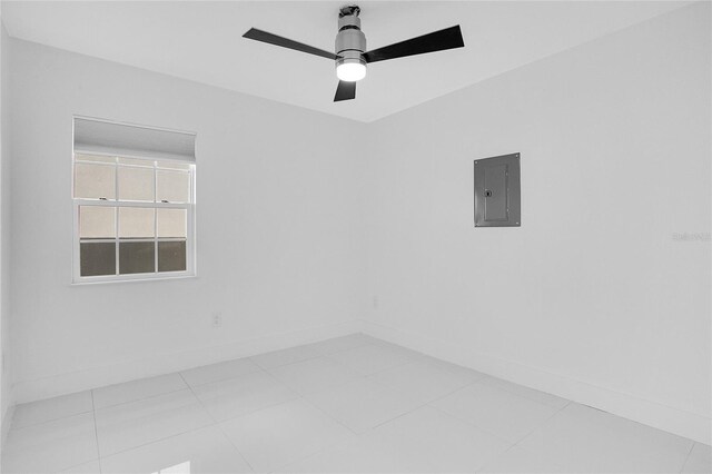 tiled empty room with ceiling fan and electric panel