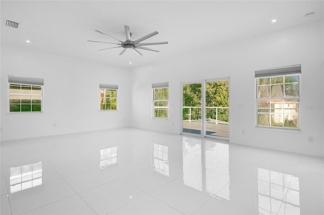 tiled spare room with ceiling fan