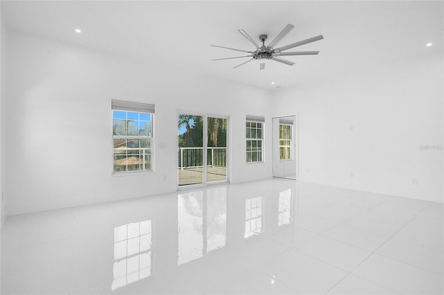 tiled spare room featuring ceiling fan