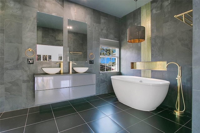 bathroom with vanity, a bathtub, and tile walls