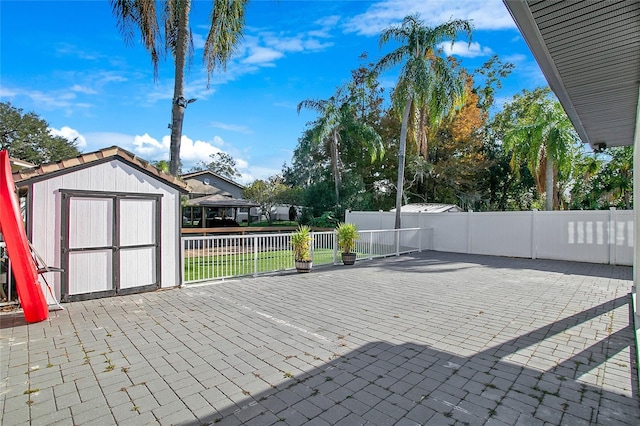 view of patio featuring a storage unit