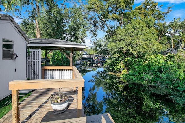 wooden terrace featuring a water view