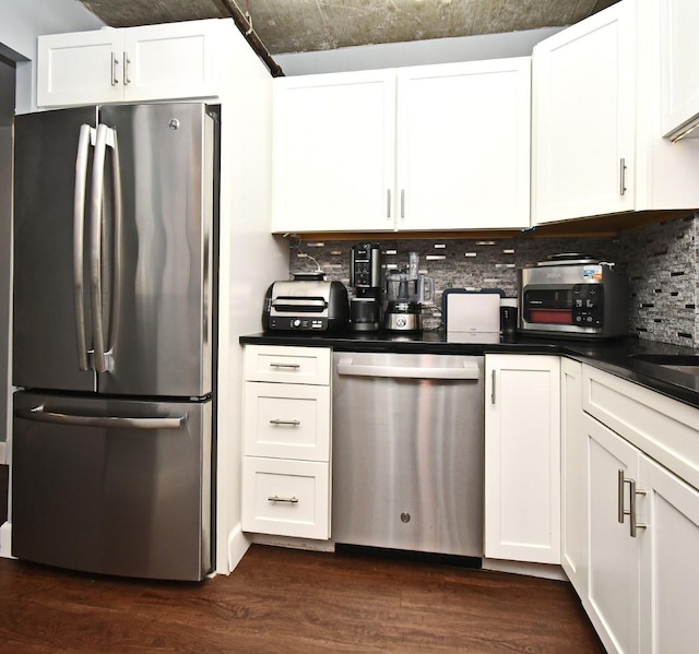 kitchen with backsplash, white cabinetry, and appliances with stainless steel finishes