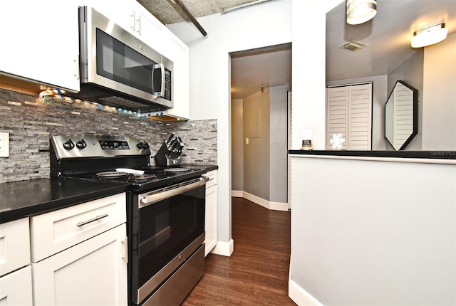 kitchen with decorative backsplash, white cabinetry, dark wood-type flooring, and stainless steel appliances