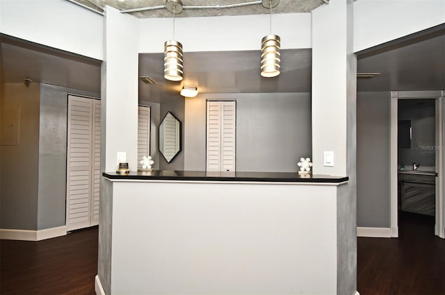 kitchen with dark hardwood / wood-style flooring and hanging light fixtures