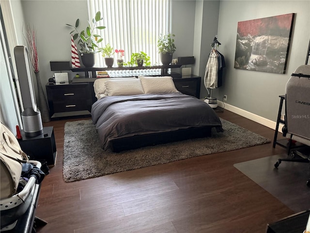 bedroom with dark hardwood / wood-style flooring