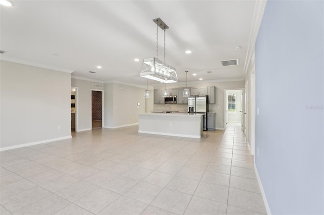 interior space featuring hanging light fixtures, a kitchen island, ornamental molding, appliances with stainless steel finishes, and light tile patterned flooring