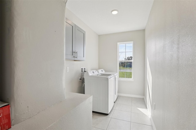 washroom featuring light tile patterned floors and washer and clothes dryer