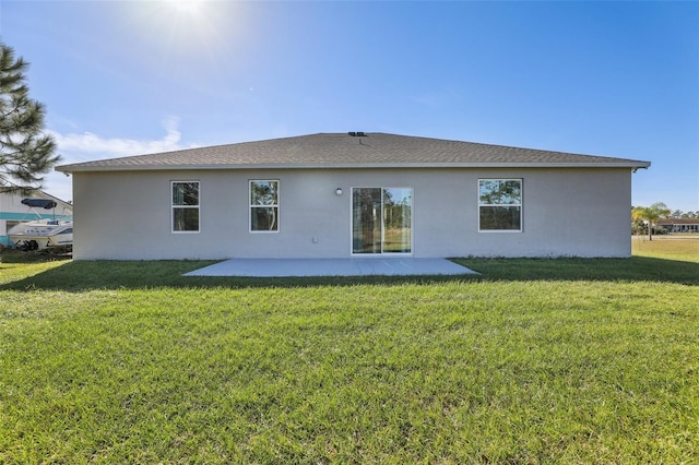 rear view of property with a patio area and a lawn