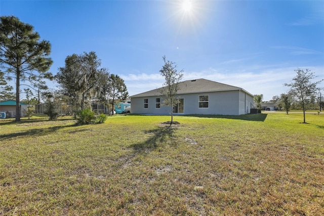 rear view of property featuring a yard