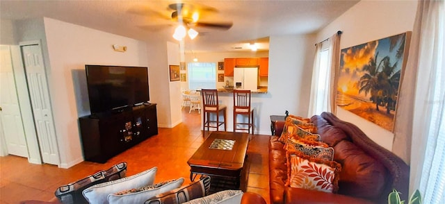 living room featuring ceiling fan and a healthy amount of sunlight