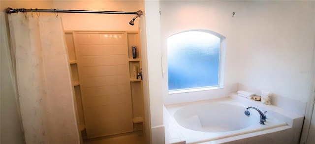 bathroom featuring separate shower and tub