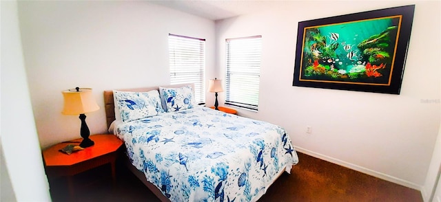 bedroom featuring dark carpet