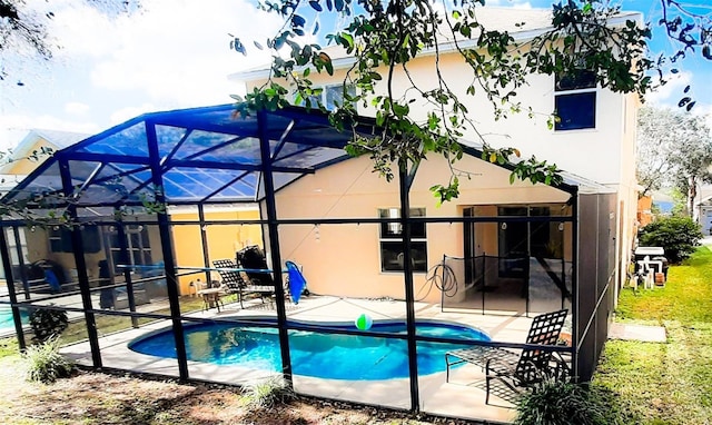 view of pool with a patio and glass enclosure