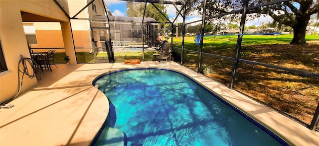 view of pool with a lanai and a patio area