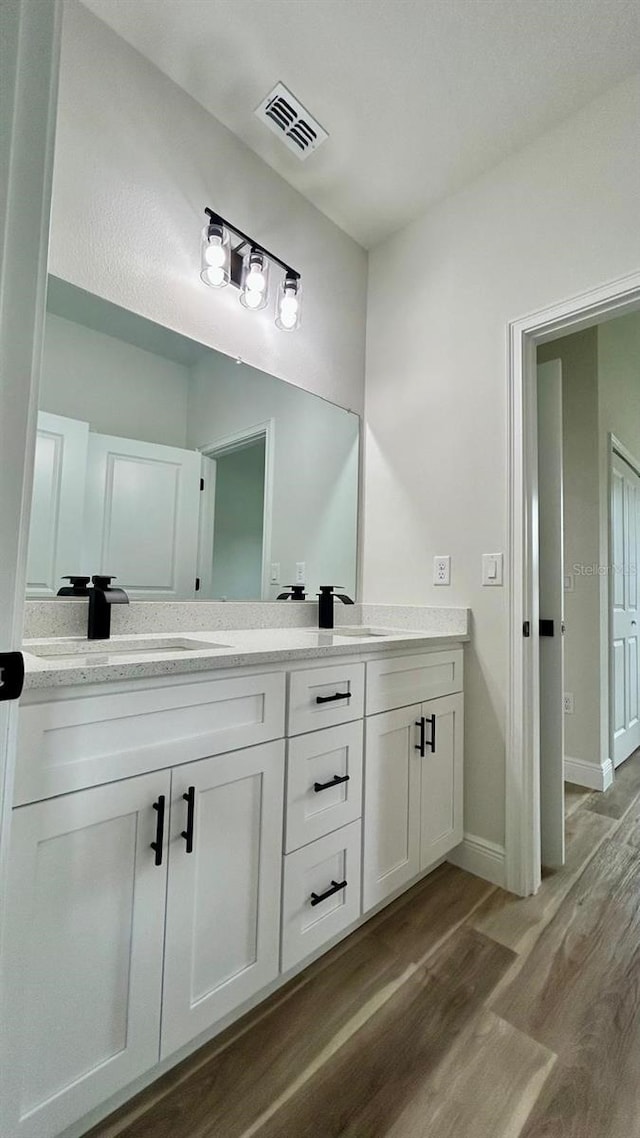 bathroom with vanity and hardwood / wood-style flooring