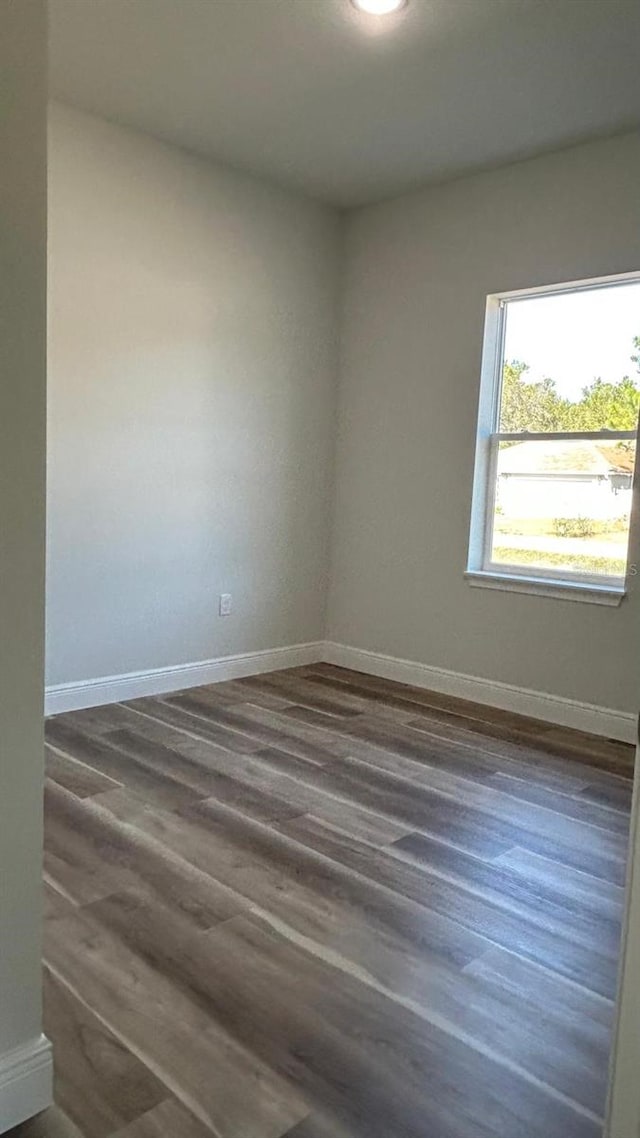 spare room featuring dark wood-type flooring