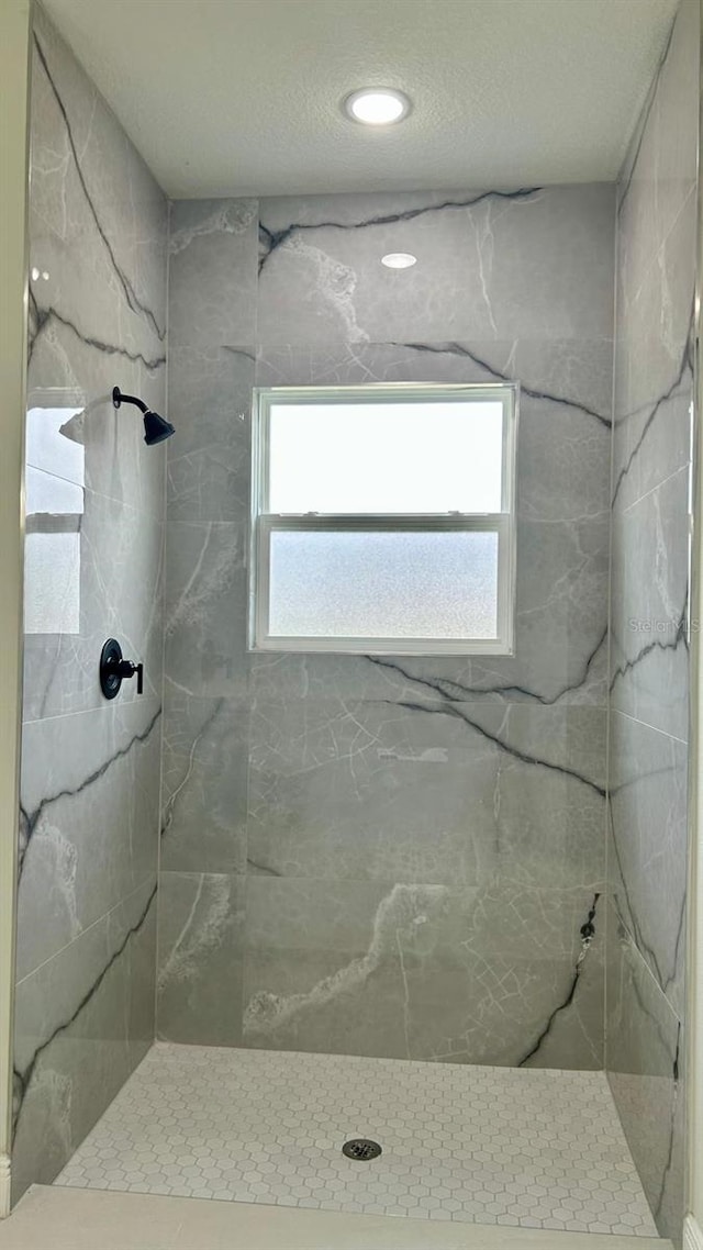 full bath featuring a marble finish shower