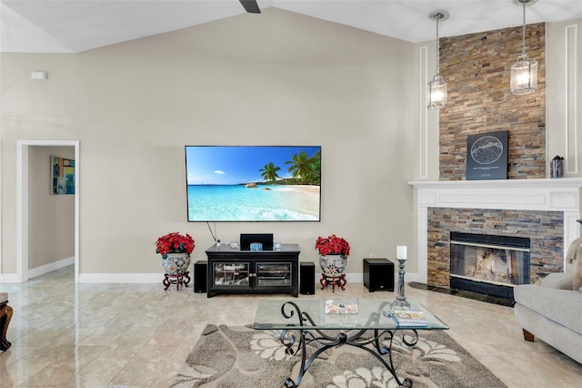 living room with a stone fireplace and high vaulted ceiling