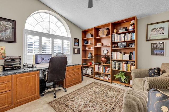 office area featuring ceiling fan, vaulted ceiling, and a textured ceiling