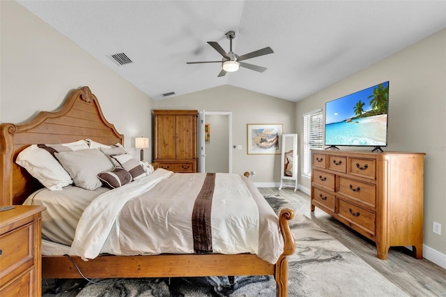 bedroom featuring lofted ceiling, light wood-type flooring, and ceiling fan