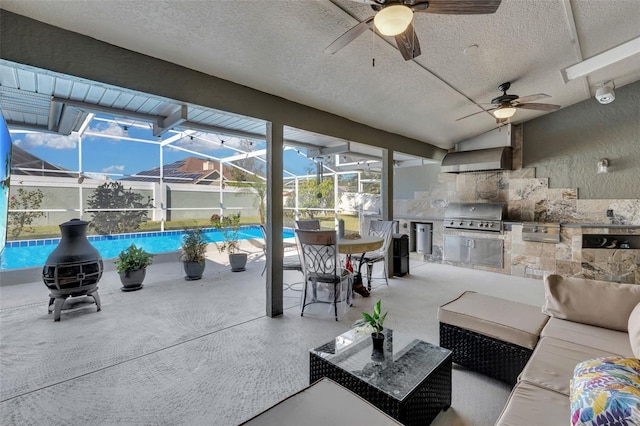 view of patio with an outdoor hangout area, a lanai, grilling area, and exterior kitchen