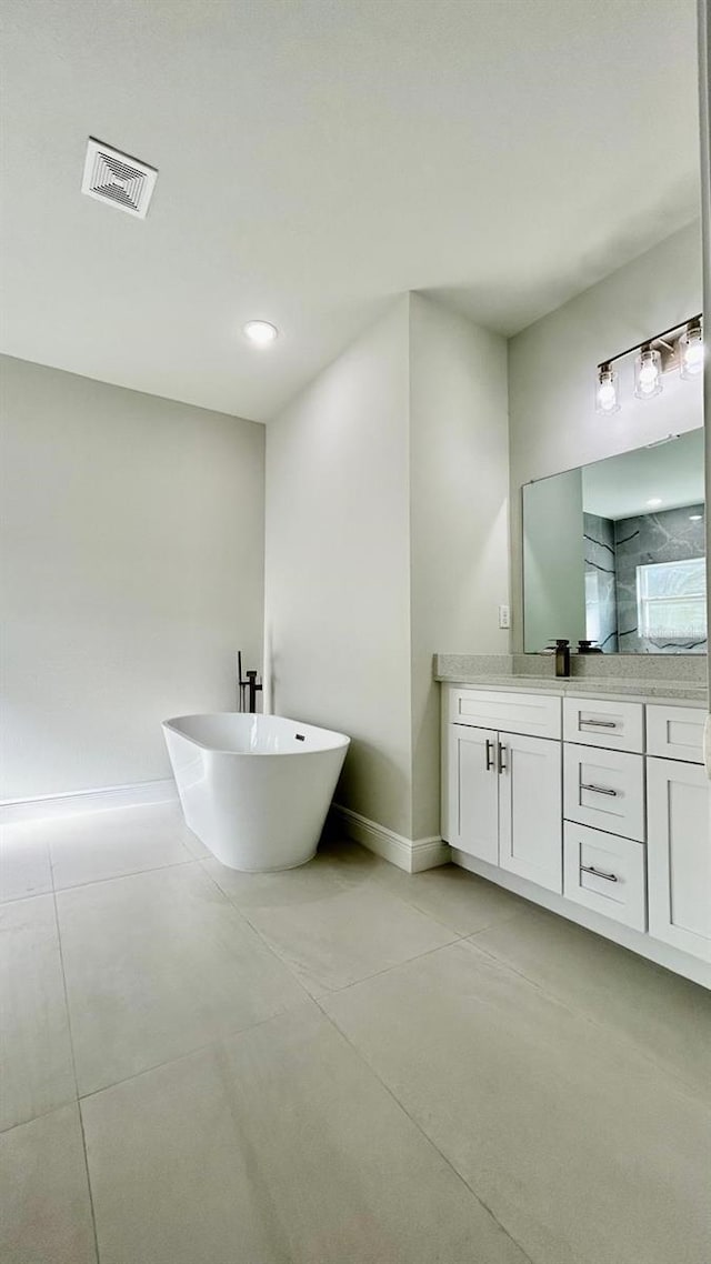 bathroom featuring a bathtub, vanity, and concrete floors