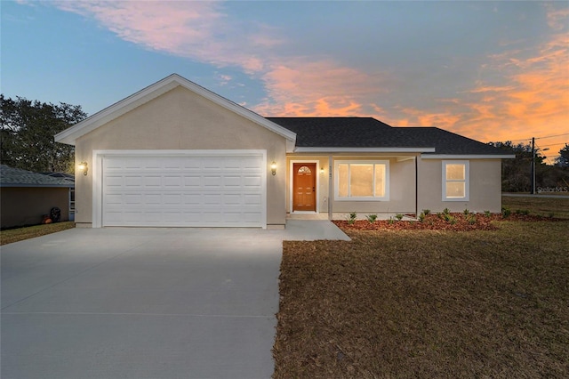 single story home with a lawn and a garage