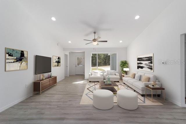 living room featuring light hardwood / wood-style flooring and ceiling fan