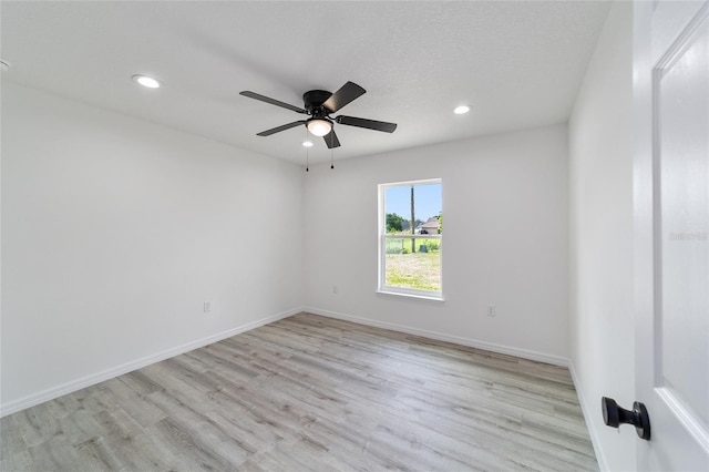 empty room with light hardwood / wood-style flooring and ceiling fan