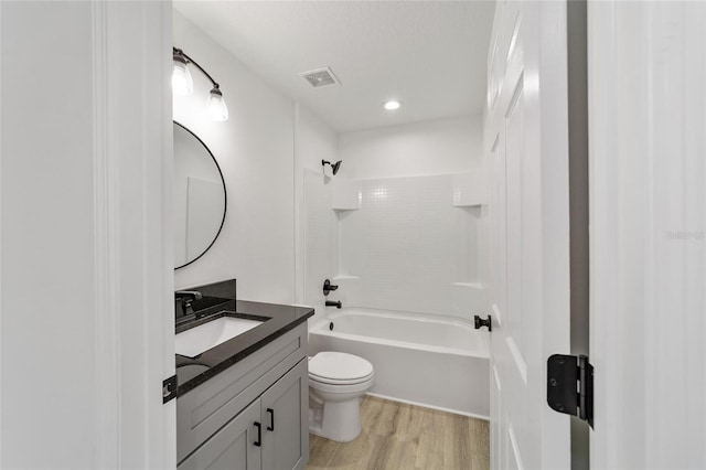 full bathroom featuring toilet, vanity, wood-type flooring, and tub / shower combination