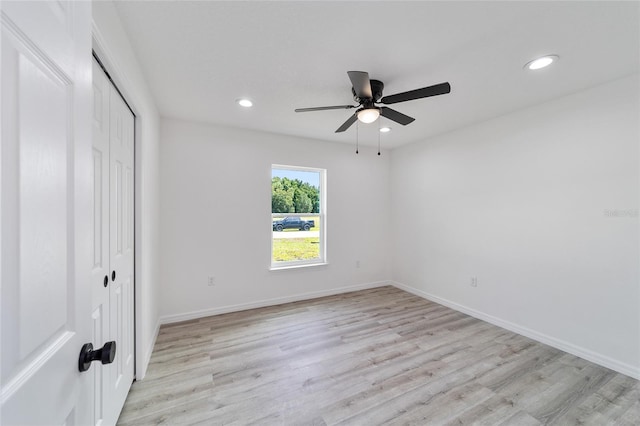 unfurnished bedroom with a closet, ceiling fan, and light hardwood / wood-style flooring