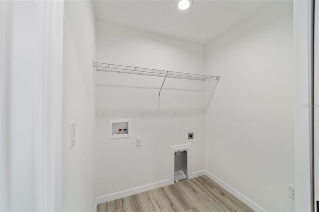 laundry area featuring electric dryer hookup, hookup for a washing machine, and light wood-type flooring