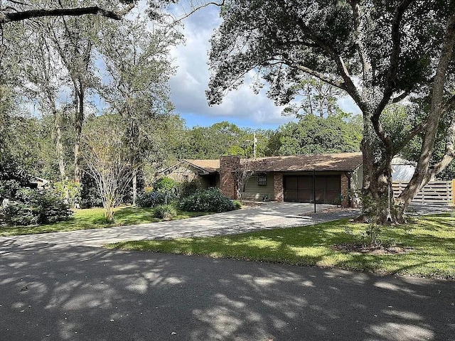 view of front of property featuring a garage and a front yard